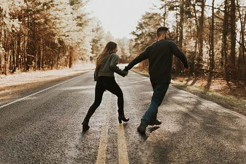 person couple on road walking
