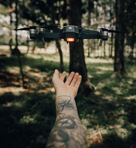 skin drone flying above hand tattoo