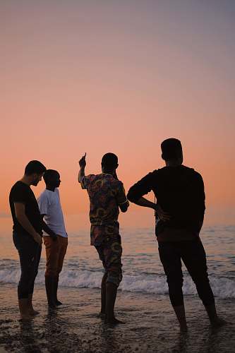 person four people standing on shore people