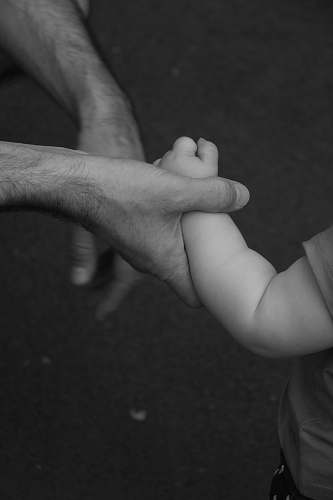 black-and-white grayscale photo of person holding toddlers grey