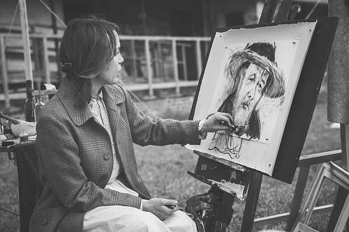 grey grayscale photography of woman sitting while painting black-and-white