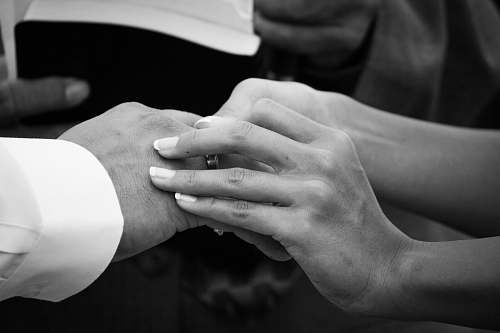 person grayscale photography of woman sucking ring on man finger black-and-white