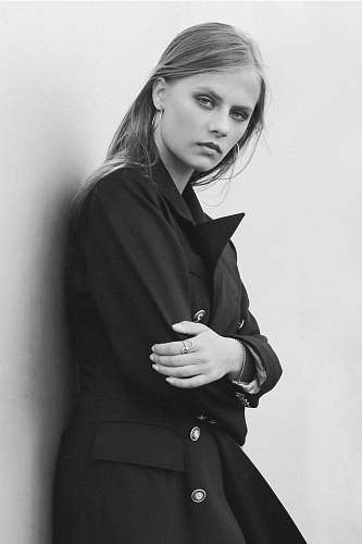 black-and-white grayscaled photography of woman on wall people
