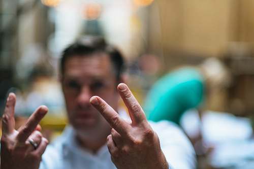 person man doing peace hand signs people