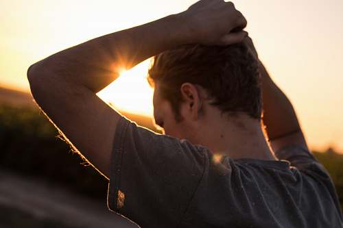 people man holding his hair against sunlight man