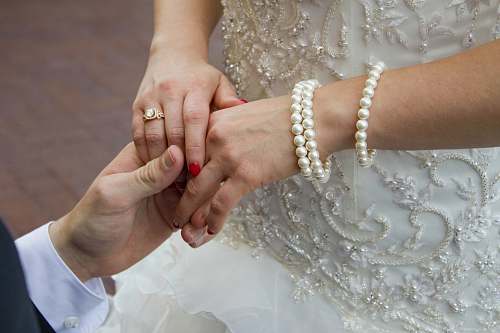 person man holding woman's hand finger