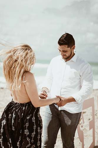 apparel man holding woman's hands clothing