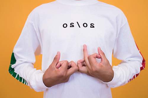 person man in white and black 20/20 printed crew-neck sweatshirt making handsigns people
