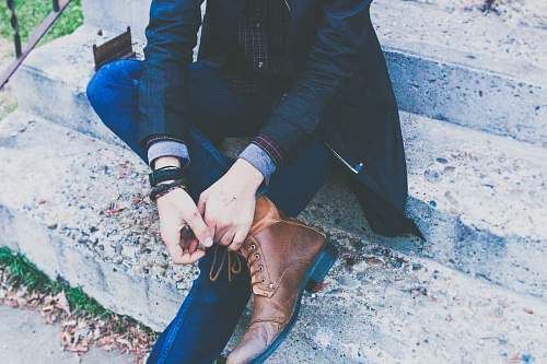 person man sitting on concrete stair hands