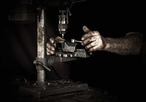 person man using drill press machine