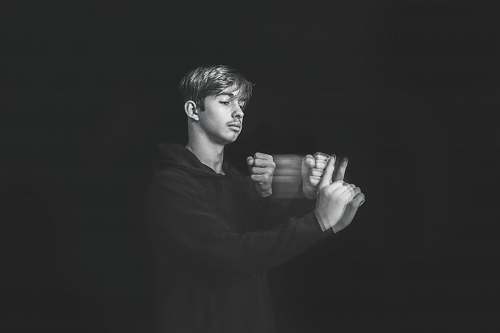 person man wearing black pullover hoodie black-and-white