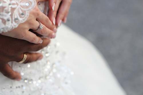 person people holding hands while wearing gold-colored wedding rings wedding