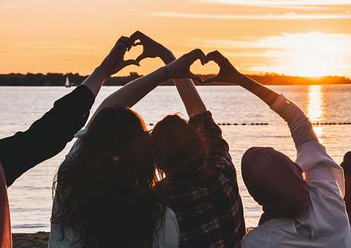 person people near body of water during golden hour sun