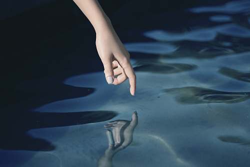 hand person about to touch water finger