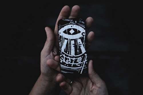 person person holding black and white phone case people