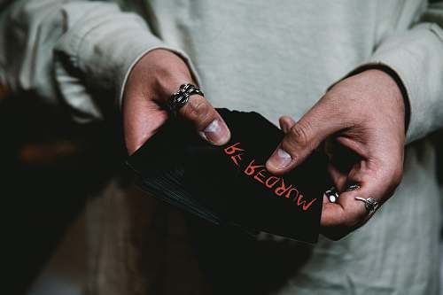 person person holding black cap finger