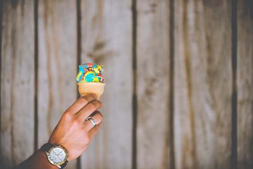 person person holding multicolored ice cream people