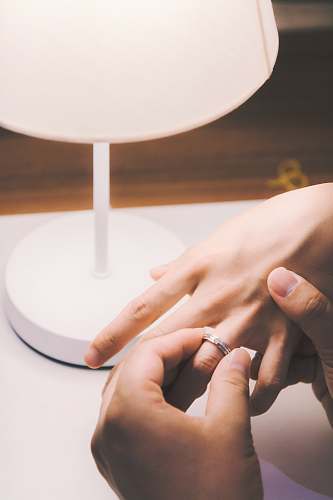 person person holding silver-colored ring lamp