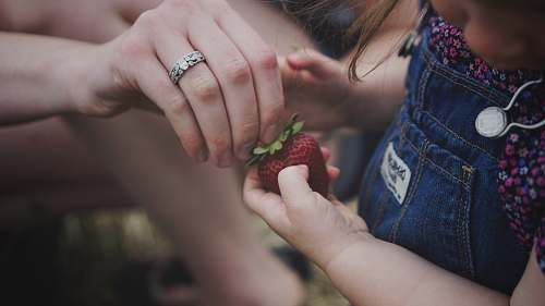 person person holding strawberry accessories