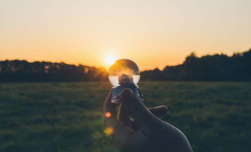 flare person holding water globe light