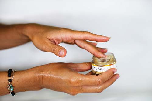 person person holding white labeled bottle hand