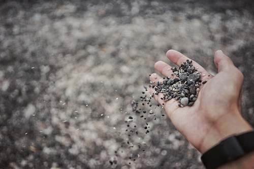 hand person pouring pebble gravel