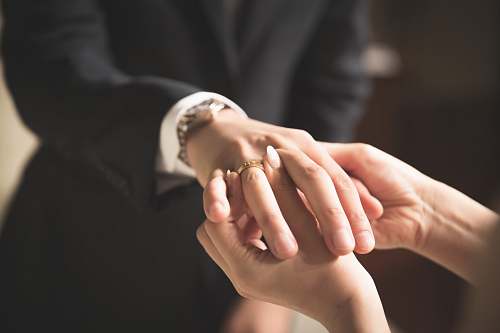 person person putting ring hand