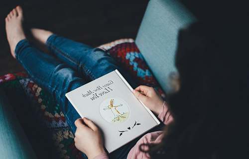 book person sitting on chair reading book kid