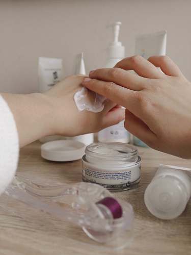 person person using cream on hand hand