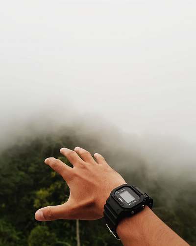 person person wearing black digital watch wristwatch