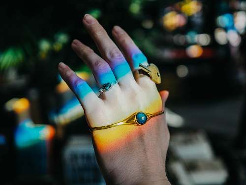 person person wearing gold-colored bracelet people