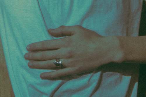hand person wearing gold-colored ring finger