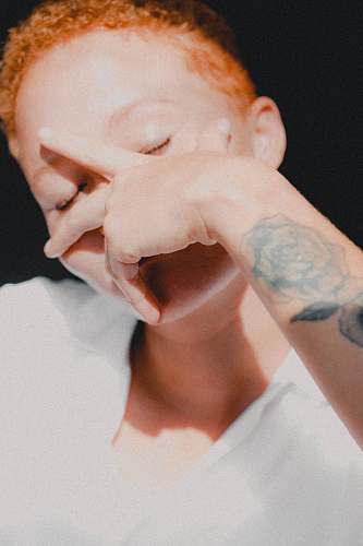 person person wearing white shirt holding face photo skin