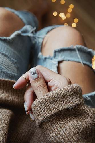 finger person with white and gray nail polish with accent hand