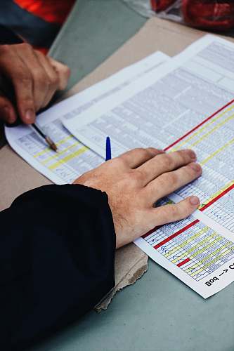 person person's hand on two stack of paper text