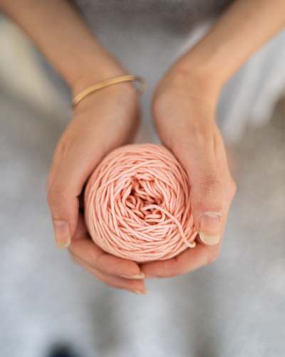 person pink thread wool