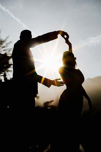 person silhouette of man and woman hand
