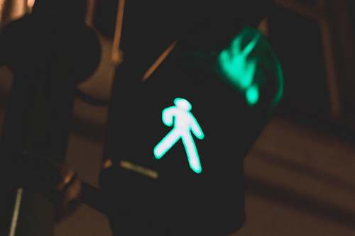 person traffic light walking sign close-up photography hand