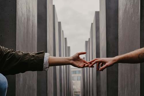 person two people reaching hands finger