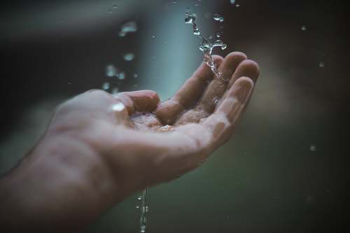 person water dew on person's palm finger