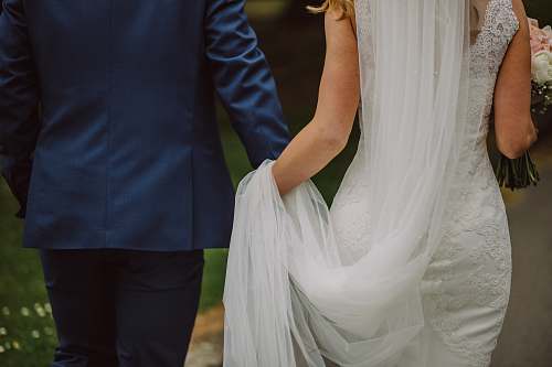 person wedding couple holding hands while walking people