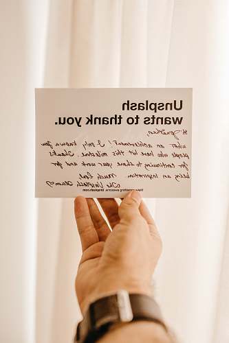 person white card with Unsplash wants to thank you printed card text