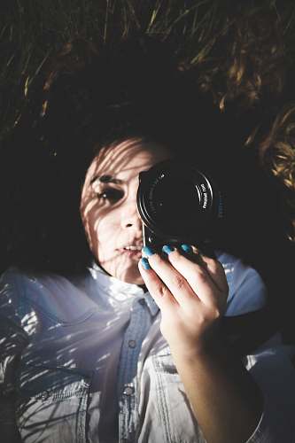person woman holding black Samsung camera people