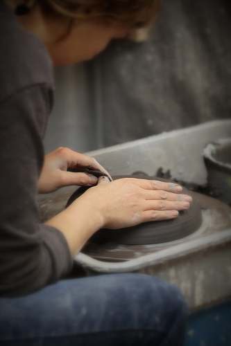 person woman molding a clay finger