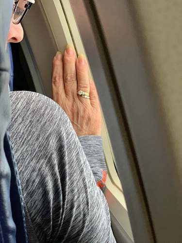 person woman wears gold-colored ring finger