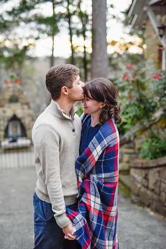 flora man kissing on woman forehead standing near tree during daytime pottery