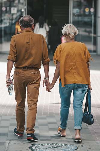 denim couple holding hands during daytime clothing