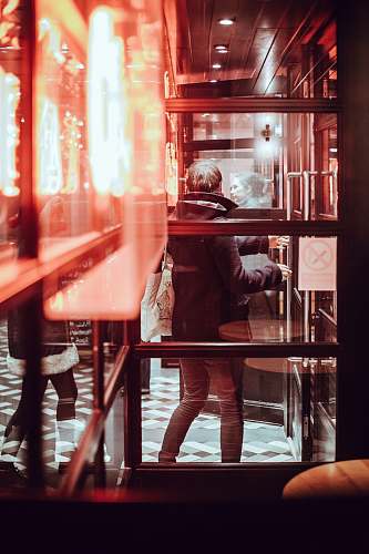 glass man standing near glass wall window