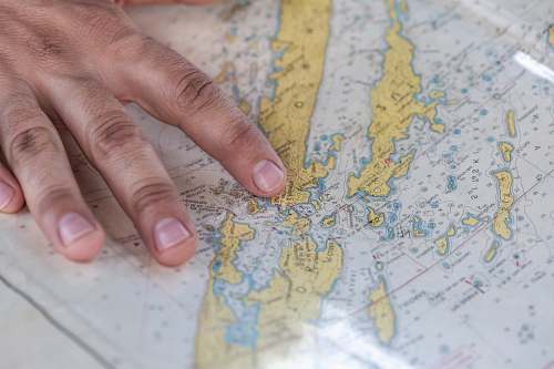 hand person holding blue and green map point