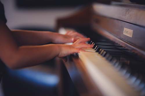 piano person playing upright piano musical instrument
